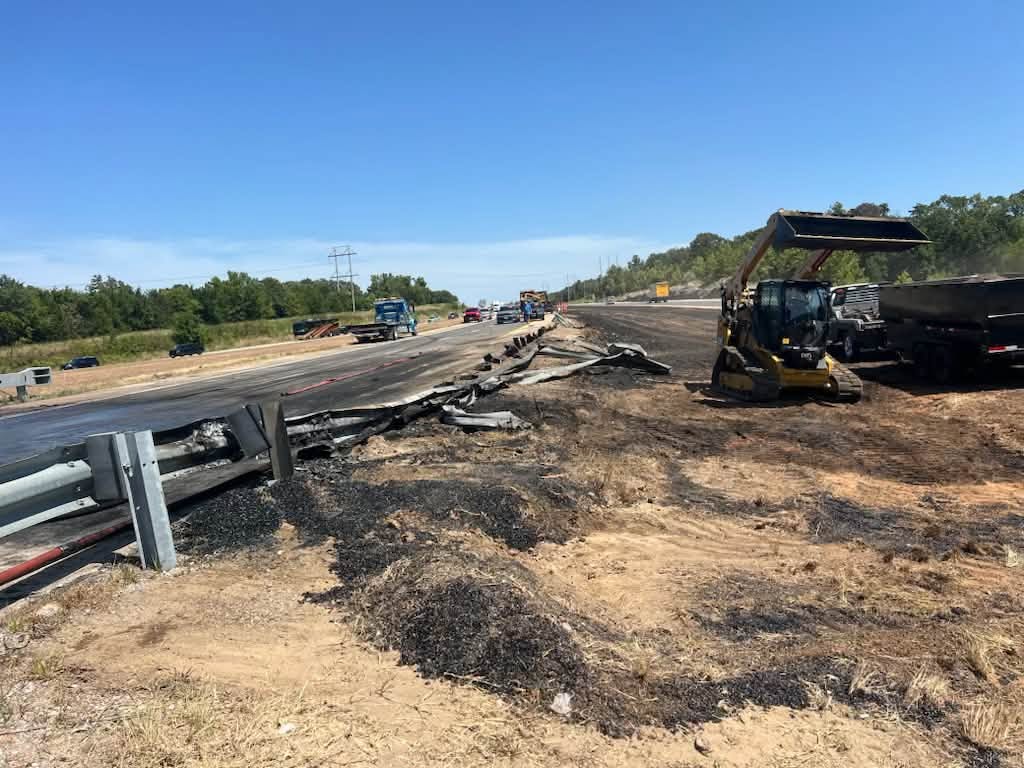 Skid steer loading spilled debris at the highway cleanup